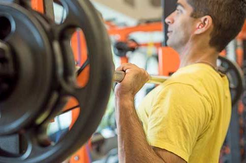 person lifting a barbell at chest level